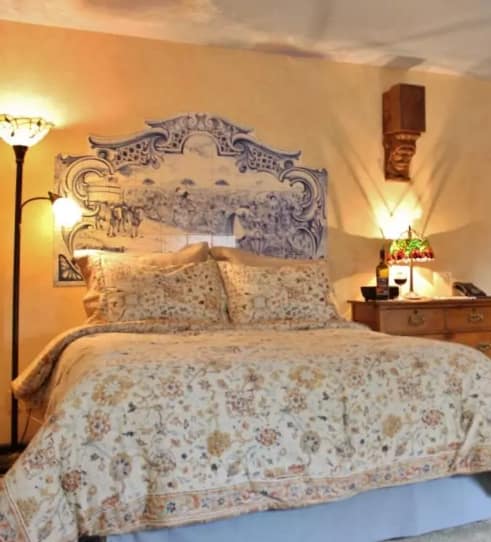 Blue Sky Suite bedroom with vintage decor and soft lighting.