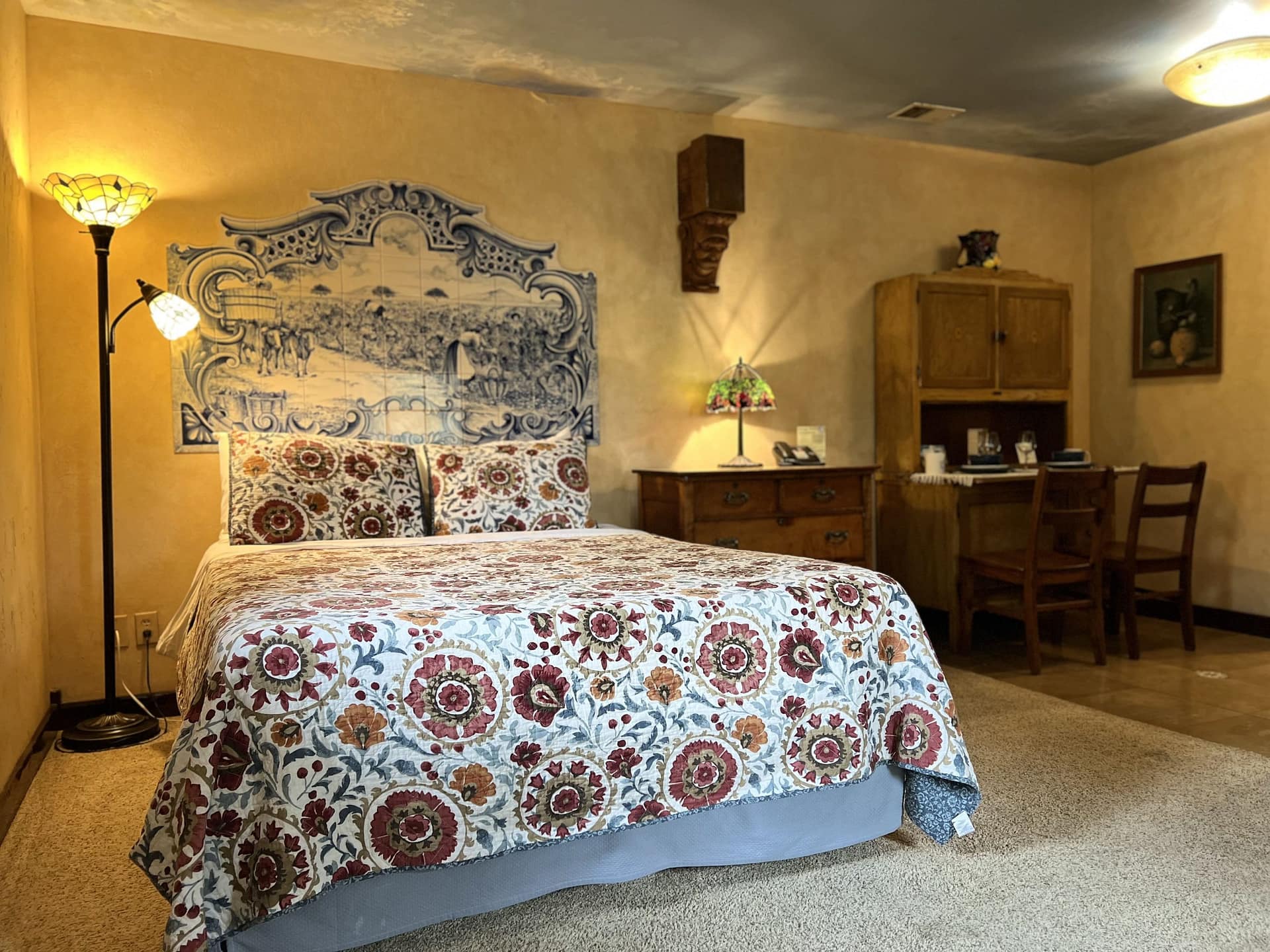 Cozy vineyard suite at Blue Sky Vineyard with vintage decor and floral bedding.