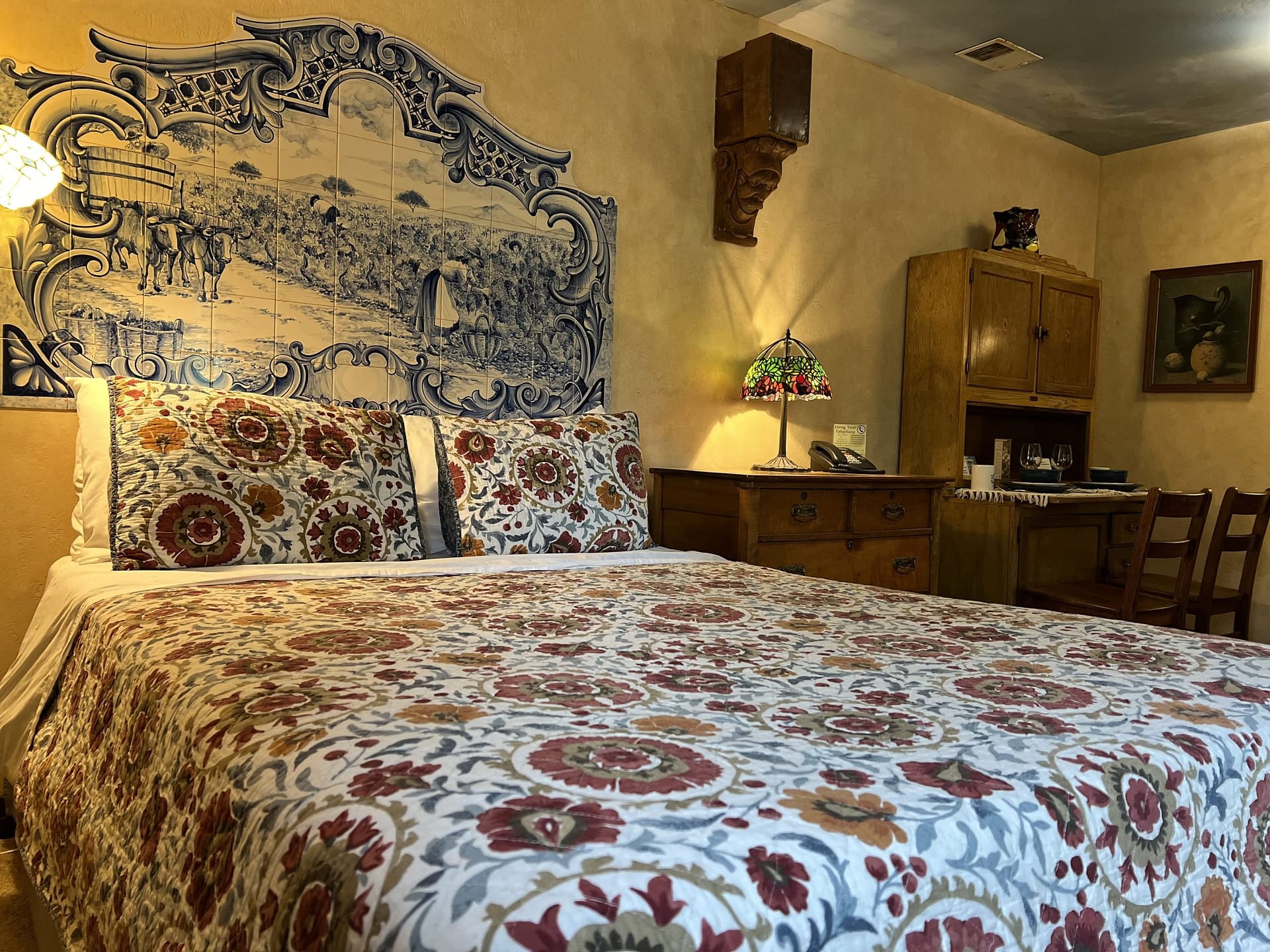 Warm and inviting bedroom at Blue Sky Vineyard with desk and floral decor.