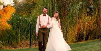 Bride and groom walking through the vineyard gardens at Blue Sky Vineyard.